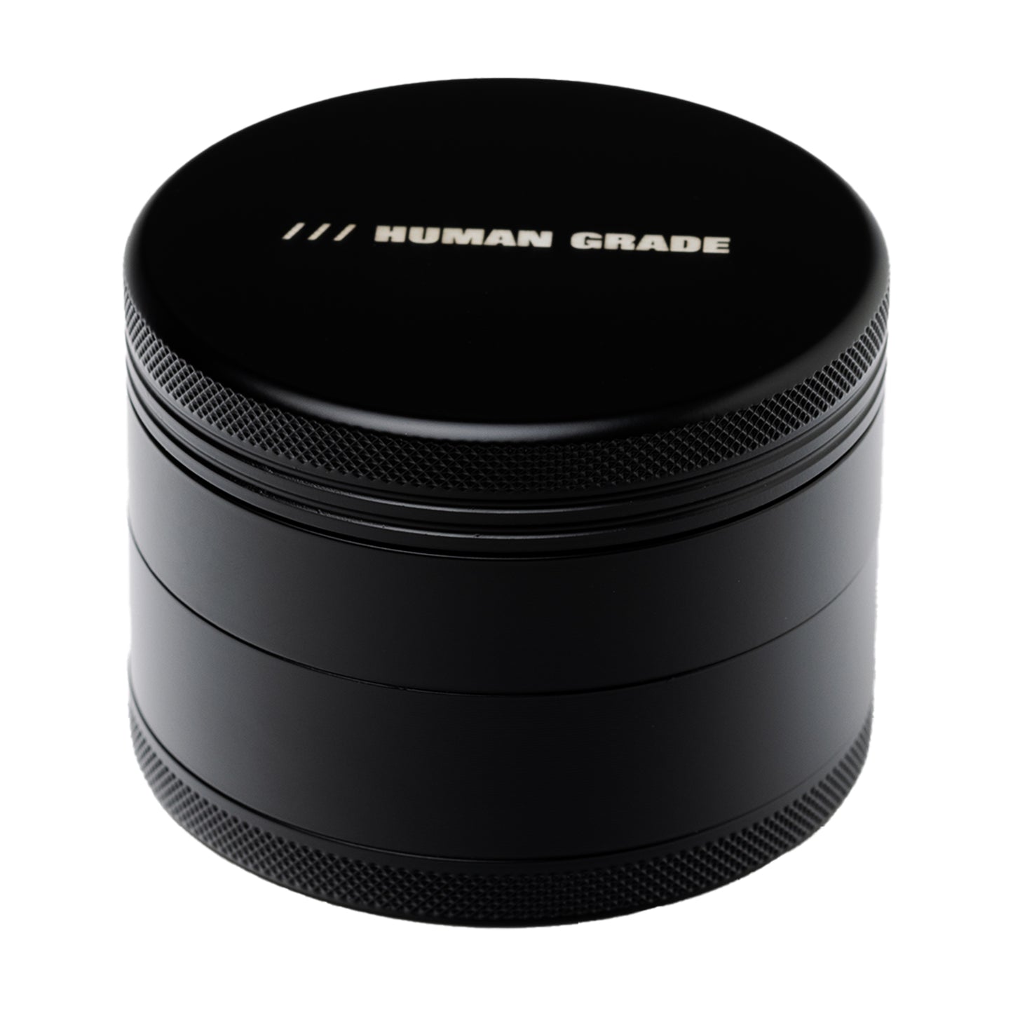 Black metal grinder with 'Human Grade' branding on a white background
